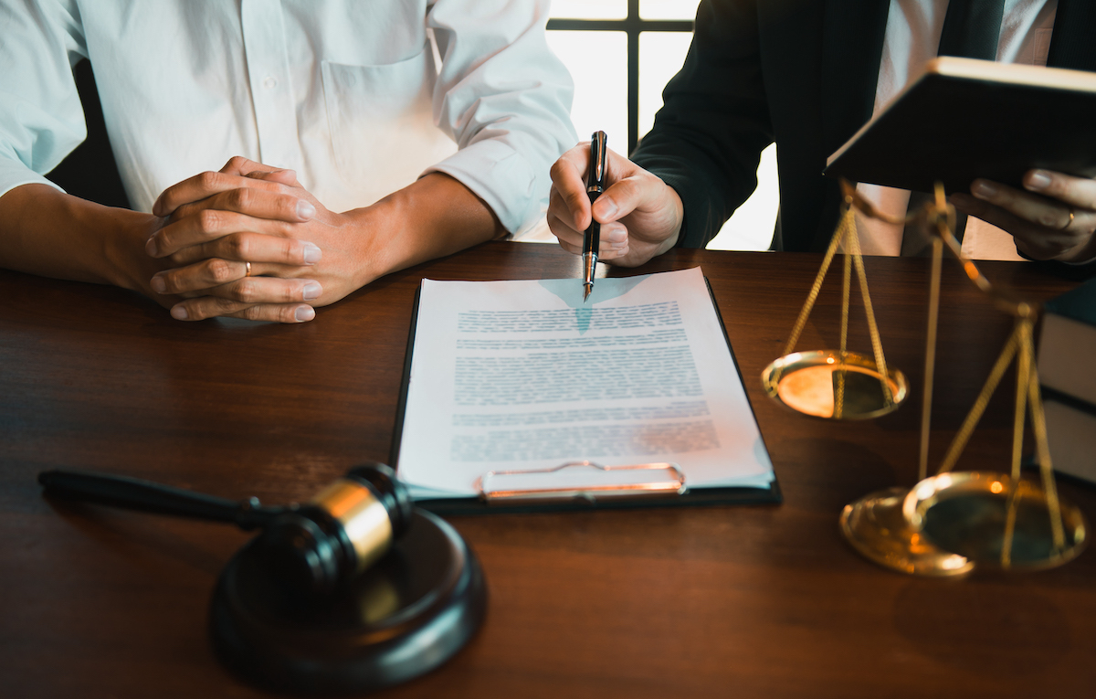 Two people signing a contract